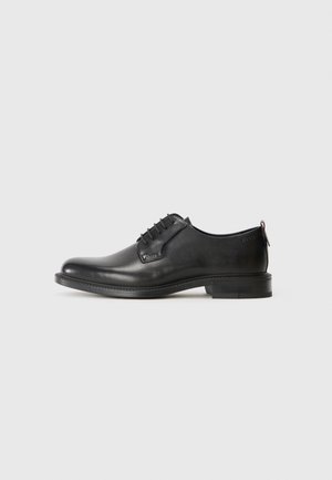 Black leather lace-up men's dress shoe with low heel and smooth finish, shown in side profile on a plain light background.