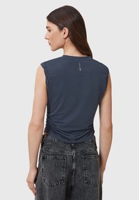 Sleeveless dark gray t-shirt with a fitted design and ruched side detail. Soft fabric with a smooth texture and minimalistic branding on the back.