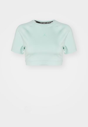 Light blue cropped athletic t-shirt made of smooth fabric. Features short sleeves and a small Jordan logo in the center.
