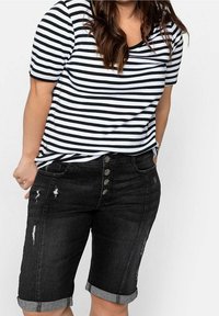 Black denim shorts with rolled cuffs, featuring light distressing and button fly, paired with a black-and-white striped t-shirt.