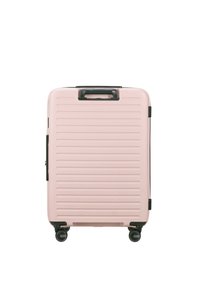 Hard-shell suitcase in light pink with horizontal ridges, black accents, a top handle, and four wheels for mobility.