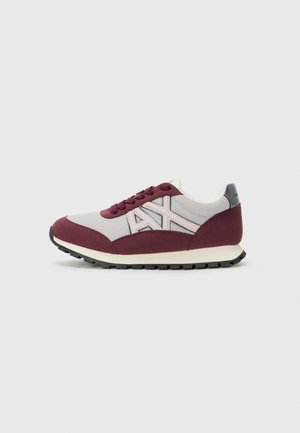 Red and gray mesh sneaker featuring a rounded toe, lace-up design, contrasting accents, and black rubber sole with textured tread.