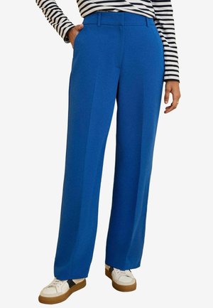 Blue wide-leg trousers with a smooth texture, featuring front pleats, belt loops, and side pockets, paired with white sneakers.