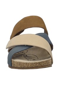 Cork-soled sandal with three cross straps in brown, beige, and blue. Features a textured footbed with a floral imprint.