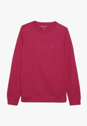 Bluza fuksja z prążkowanym okrągłym dekoltem, długimi rękawami oraz wytłaczanym logo "GUESS" z przodu. Wykonana z miękkiego bawełnianego materiału.