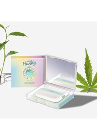 Un ensemble de papier buvard dans un étui transparent avec un miroir. Le produit comprend deux tampons texturés avec une bande verte claire et un emballage pastel.
