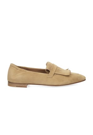 Beige suede loafer with low wooden heel, pointed toe, and fringed strap detail across the top.