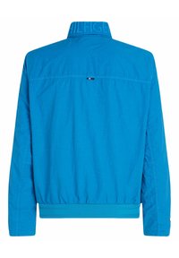 Blaue Nylonjacke mit einem strukturierten Kragen, elastischem Bund und einem Logo auf der Rückseite. Verfügt über einen kontrastierenden Streifen neben dem Kragen.