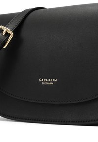 Black leather crossbody bag with a textured finish. Features a gold logo, a flap closure, and an adjustable strap. Simple, sleek design.