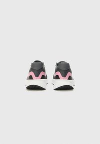 Chaussures de sport noires avec un dessus texturé, ornées d'accents roses et d'une semelle blanche. Conception basse avec un col rembourré et une semelle extérieure flexible.