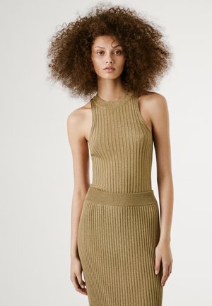 Knit dress in a warm beige tone, featuring a ribbed texture, sleeveless design, high neckline, and a fitted silhouette.
