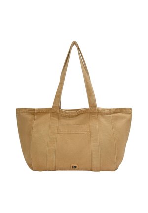 Large beige canvas tote bag with two sturdy handles, featuring a front pocket and subtle branding on a rectangular patch.