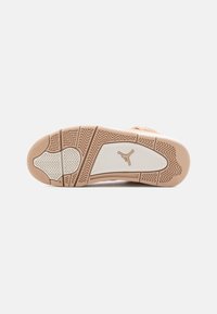 Light tan sneaker sole with a white midsole. Features textured rubber for traction, distinct tread pattern, and a logo emblem.