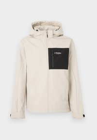 Veste beige à capuche avec fermeture éclair intégrale à l'avant, poche poitrine zippée noire étiquetée "JJ Studios" sur le côté gauche, poignets réglables.