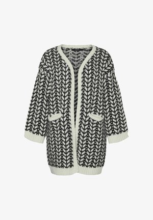 Long gilet noir et blanc avec un motif en chevrons, à l'avant ouvert, avec des manches larges et deux poches sur le devant. Texture en tricot douce.