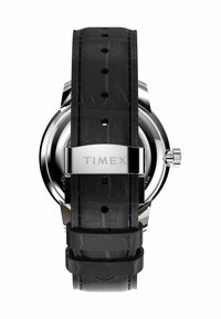 Black leather watch strap with textured surface, stainless steel clasp displaying "TIMEX," rounded case, and prominent crown detail.