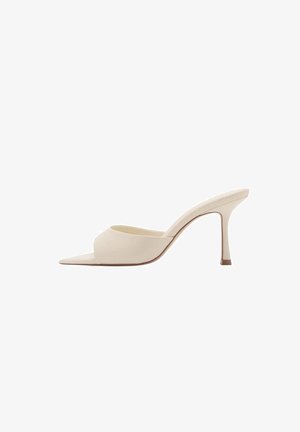 Pointed-toe mule in soft beige patent leather with a slim high heel and open back, featuring a smooth texture and minimalist design.
