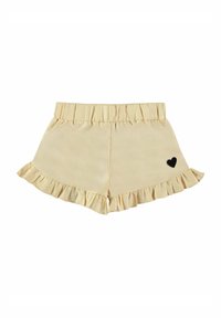Gelbe Rüschenshorts mit einem elastischen Bund und einem kleinen schwarzen Herzen als Akzent an der Seite. Weicher, glatter Stoff.