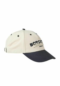 Baseball cap med en kremfarvet stofkrop og en mørkeblå skygge. Har broderet tekst og sorte ventilationshuller. Justerbart bagbånd.
