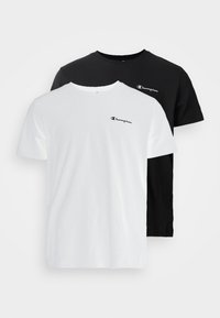 Two short-sleeve T-shirts in white and black cotton, featuring a small Champion logo on the chest. Simple crew neck design.