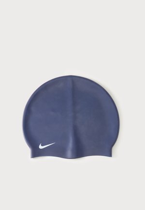 Bonnet de bain en silicone bleu marine avec logo Nike blanc en bas à gauche, présenté sur un fond clair.