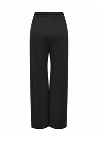 Schwarze weit geschnittene Hose mit elastischem Bund. Hergestellt aus weichem Stoff, mit glatter Textur und ohne sichtbare Muster oder Verzierungen.