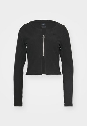 Black, ribbed, cropped zip-up jacket with long sleeves, featuring a round neckline and silver hardware. Small logo accent near zipper.