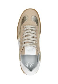 Beige suede sneaker with gold metallic accents, textured white leather detailing, and flat laces. Textured rubber sole with brand logo visible.