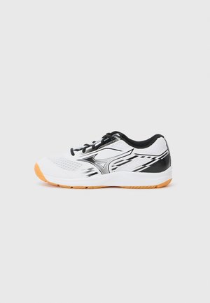 White athletic shoe with black accents, mesh upper, and synthetic overlay. Features orange rubber sole and black laces. Streamlined design.