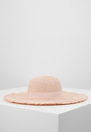 Light pink wide-brimmed woven sun hat with a matching fabric band, displayed on a white pedestal against a gray background.