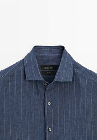 Blue linen shirt with thin white vertical stripes, spread collar, and grey buttons, labeled Massimo Dutti.