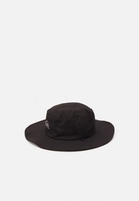 Schwarzer Stoff-Bucket-Hat mit breiter Krempe, genähten Details und einem Logo auf einer Seite. Das Design ist rund und verfügt über Lüftungsöffnungen.