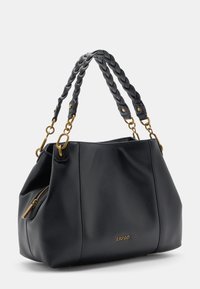 Sac à main en cuir noir avec une finition texturée, des poignées tressées et des accessoires en ton doré. Dispose d'une poche zippée pour plus de fonctionnalité.