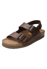 Sandale en cuir marron avec deux brides réglables, une semelle en liège et une semelle en caoutchouc texturée. Présente un logo de la marque sur le côté.
