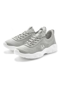 Gray mesh athletic shoes with a textured upper, elastic collar, and white rubber sole. Features lace-up design and logo detail.