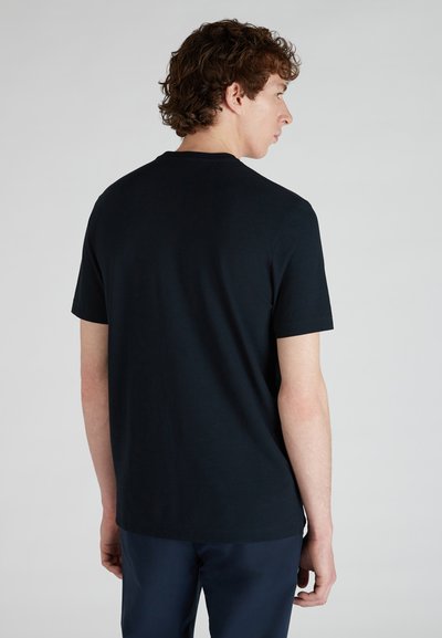 T-shirt noir à manches courtes en coton, avec un col rond et une coupe décontractée, présenté de dos. Texture lisse, sans motifs visibles.