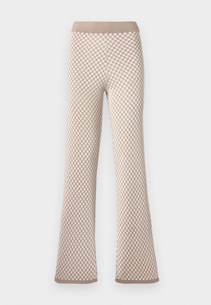 Pantalones de punto a cuadros en beige y blanco con cinturilla elástica y ligera campana en los tobillos sobre fondo blanco.