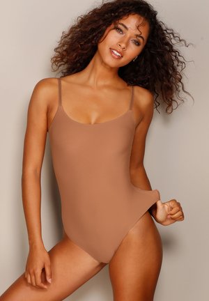 Brown one-piece swimsuit with thin straps, smooth texture, and a classic design. It features a high-cut leg and a minimalistic style.