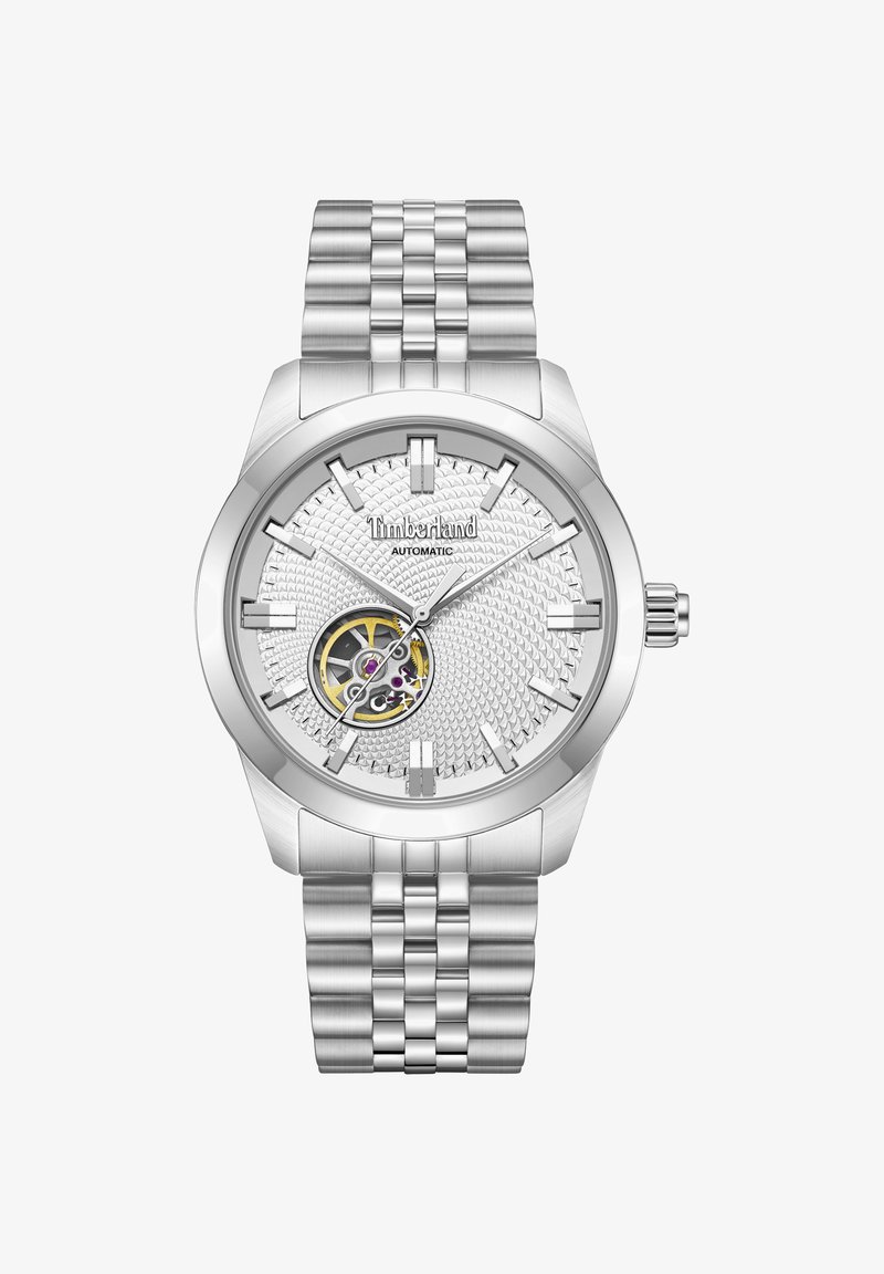 Montre automatique Timberland argentée avec cadran texturé, mécanisme d'engrenage visible à 7 heures, index argentés et bracelet à maillons en acier inoxydable.