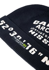 Navy knit beanie with white text reading "CALIFORNIA NORTHWEST MISSOURI" and coordinates. Features a green and black label.
