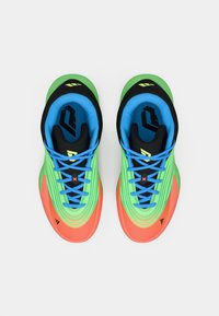Multicolored athletic shoes with a green upper, orange toe cap, and blue details. Features textured material, patterned design, and black accents.