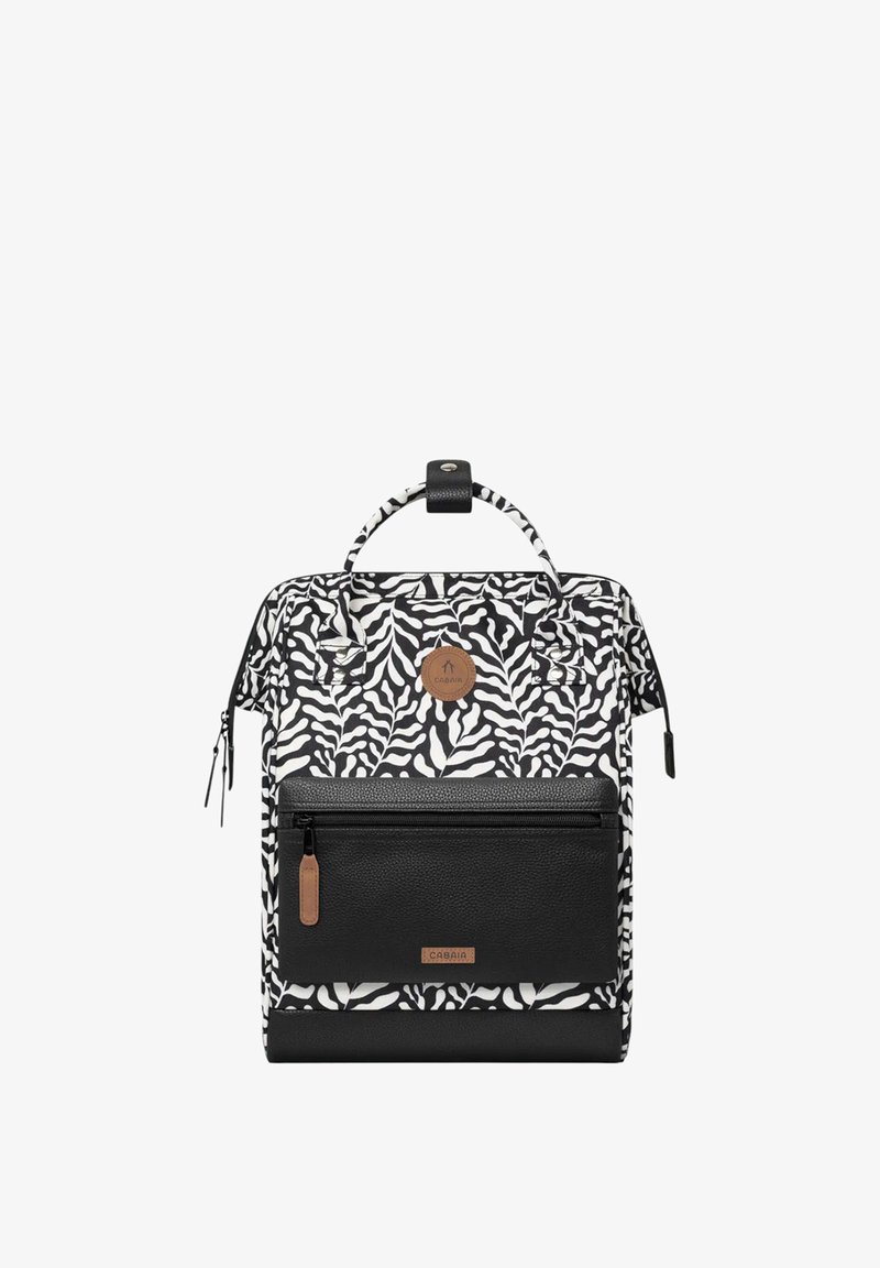 Zebra-patterned backpack in black and white with a textured black bottom, front zip pocket, and a round logo patch. Features dual handles and zippers.