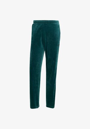 Pantaloni jogger in velluto verde con vita elasticizzata, caratterizzati da una vestibilità slim e dettagli del logo nero sulla coscia. Texture morbida in tutto il capo.