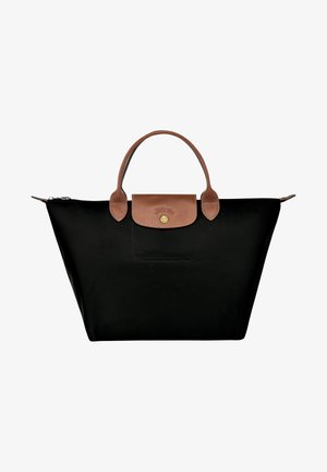 Black nylon tote bag with brown leather handles and flap. Gold logo detail on flap. Zipper closure at top, ample interior space.