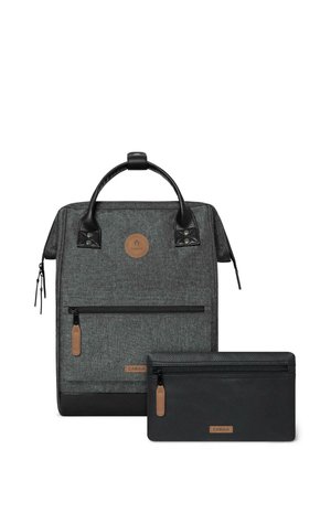 Gray fabric backpack with a black base, featuring a brown logo patch, front zip pocket, and a matching black zippered pouch.