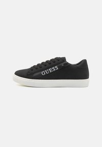 Black sneakers with a smooth texture, featuring a white logo, lace-up design, and a contrasting white sole. Minimalist and modern style.