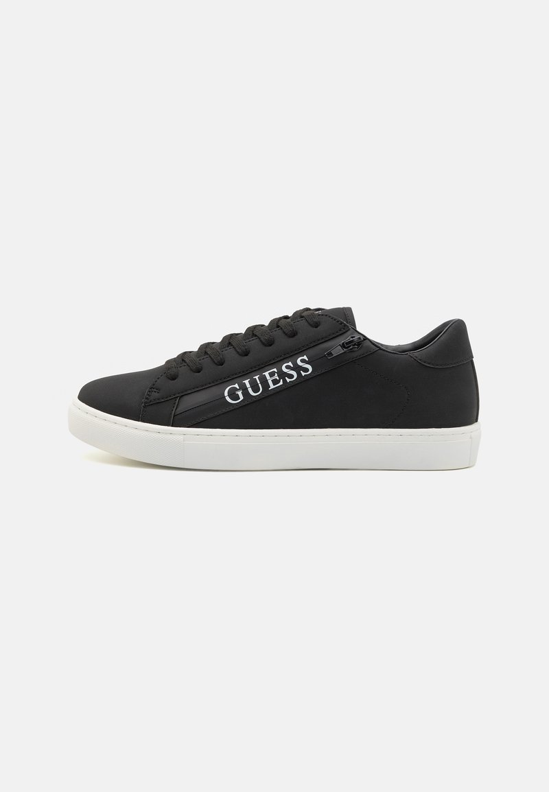 Black sneakers with a smooth texture, featuring a white logo, lace-up design, and a contrasting white sole. Minimalist and modern style.
