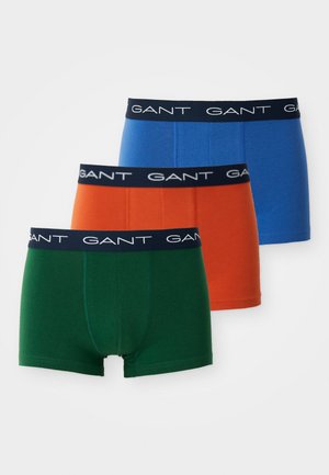 Three pairs of GANT boxer shorts: green, orange, and blue. Cotton material with elastic black waistband featuring white brand logo.