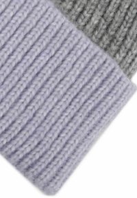 Knit wool fabric in light lavender and gray. Features ribbed texture with visible stitching and a soft, warm appearance.