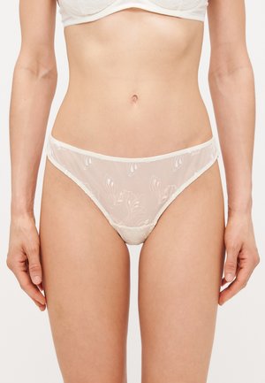 Sheer white thong with floral embroidery, delicate lace trim, and a soft texture. Features a low-rise design for minimal coverage.
